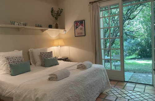Villamblard Bed & Breakfast | A beautiful romantic bedroom with a mezzanine area, bathroom and private garden