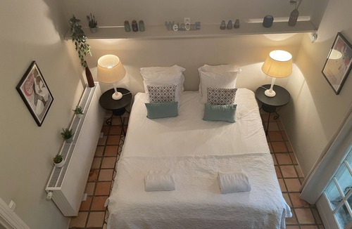 Villamblard Bed & Breakfast | A beautiful romantic bedroom with a mezzanine area, bathroom and private garden
